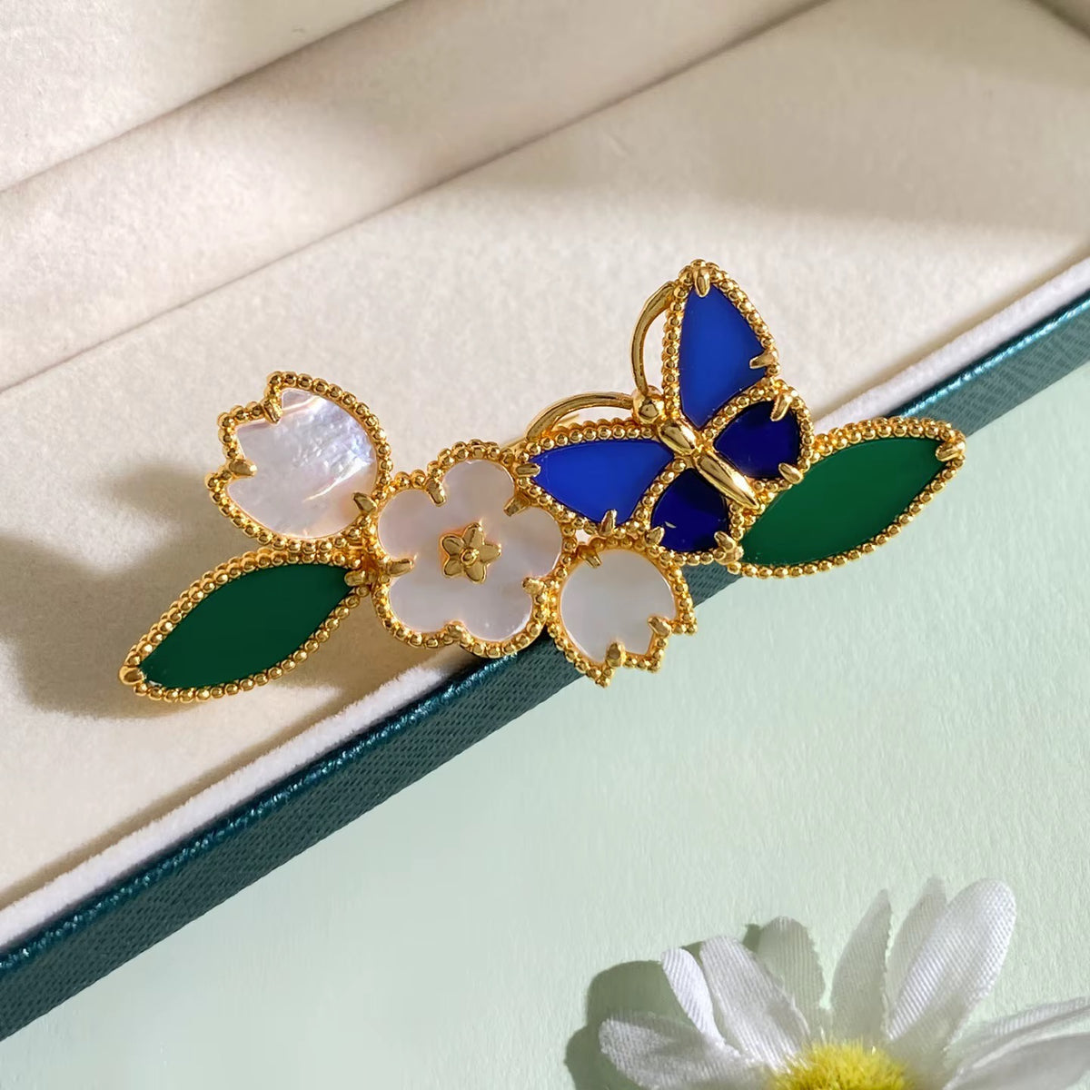 Jardin d’Azur butterfly and flower jewelry detail – Aura Jewels