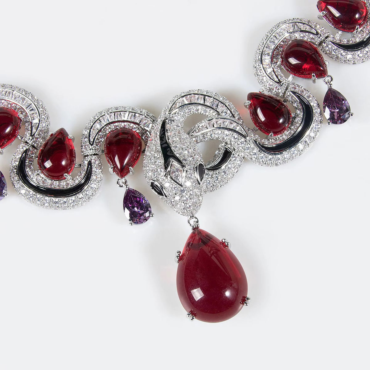 Close-up of deep red pear-cut stones on the Éclat Royal jewelry set